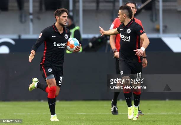 Goncalo Paciencia celebrates with teammate Rafael Santos Borre of Eintracht Frankfurt after scoring their team's first goal from the penalty spot...