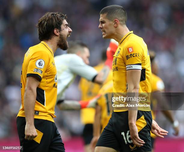 Conor Coady of Wolverhampton Wanderers celebrates with teammate Ruben Neves after scoring their side's second goal during the Premier League match...