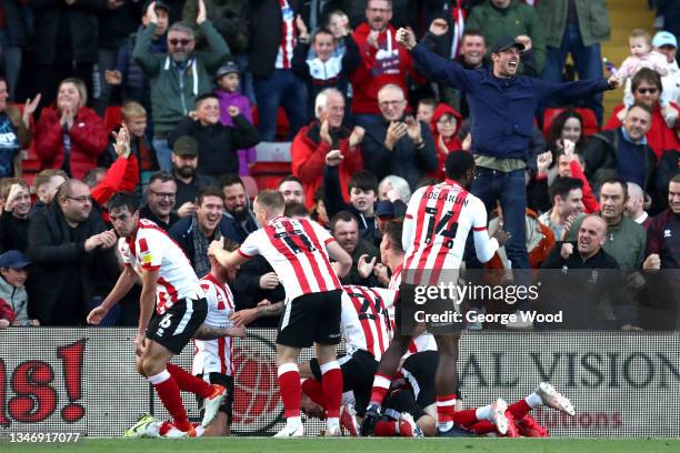 Lincoln City fans celebrate their second goal scored by Regan Poole during the Sky Bet League One match between Lincoln City and Charlton Athletic at...