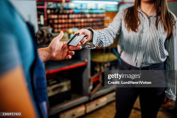 car mechanic taking the credit card from customer - handing over credit card stock pictures, royalty-free photos & images
