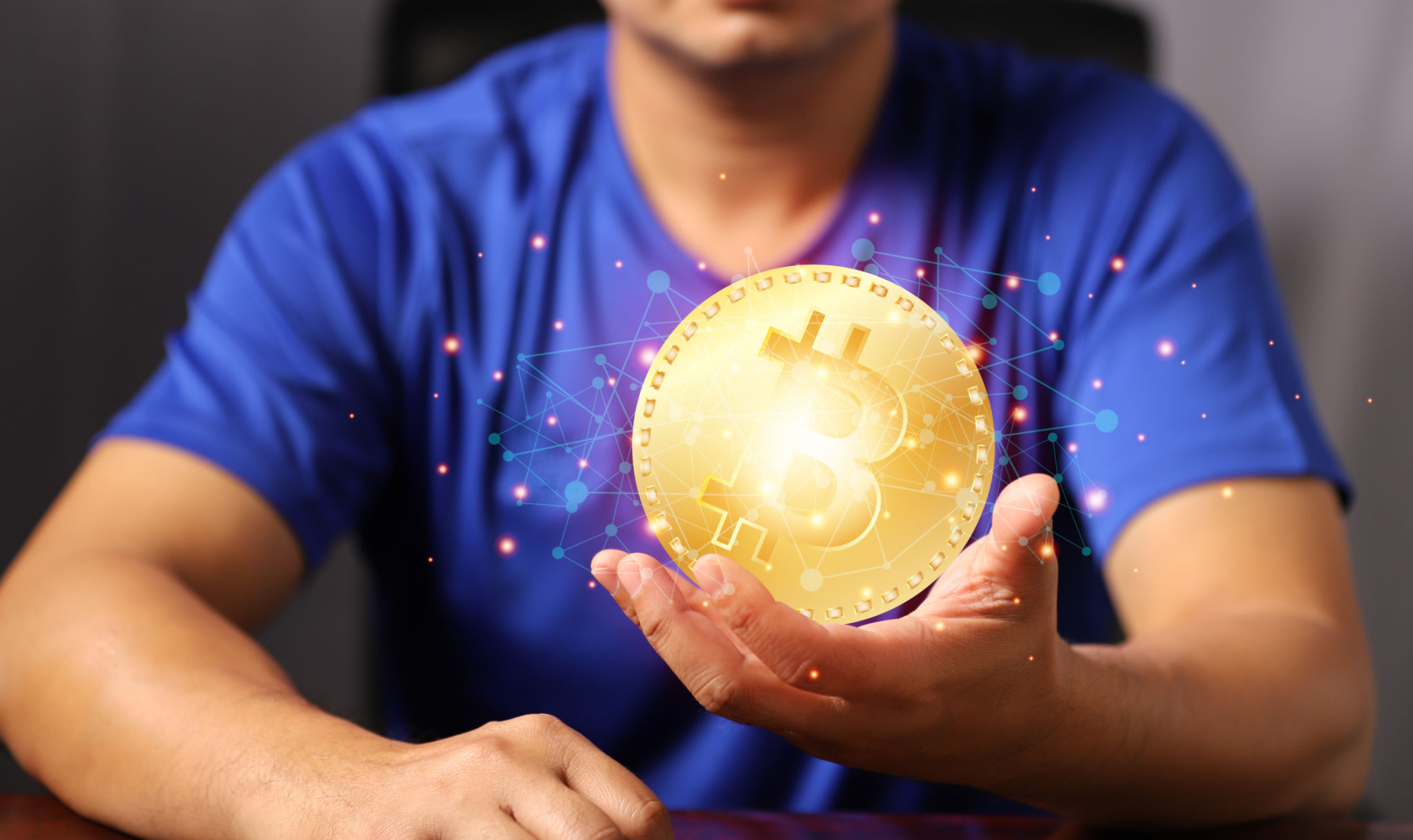 Blockchain technology and network concept. Man holding bitcoin hand with icons network connection on blue security and digital connection background. Blockchain technology and network concept. Man holding bitcoin hand with icons network connection on blue security and digital connection background.