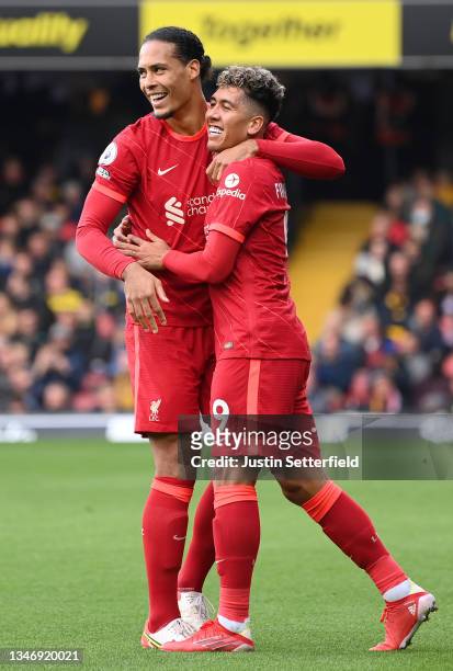 Roberto Firmino of Liverpool celebrates after scoring their side's third goal with Virgil van Dijk of Liverpool during the Premier League match...