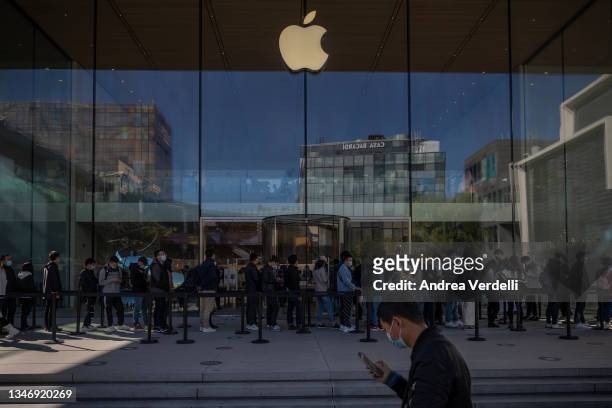 People queue to get into an Apple store on October 16, 2021 in Beijing, China. According to an action plan released on October 14, Beijing has...