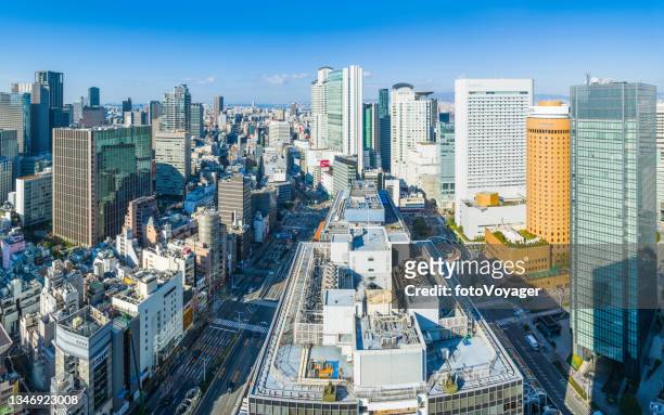 aerial panorama over highrise cityscape skyscrapers and highways osaka japan - osaka prefecture stock pictures, royalty-free photos & images
