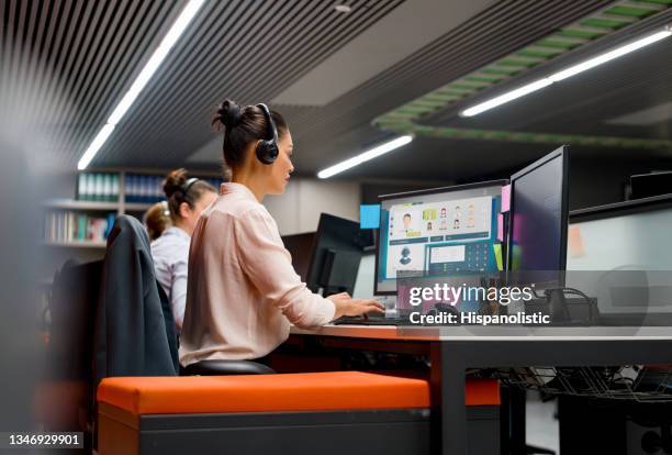 group of customer service representatives working at a call center - customer service representative stock pictures, royalty-free photos & images