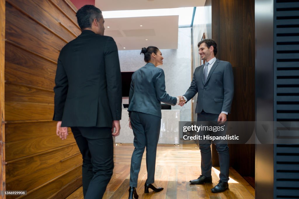 Happy business man greeting his associates with a handshake