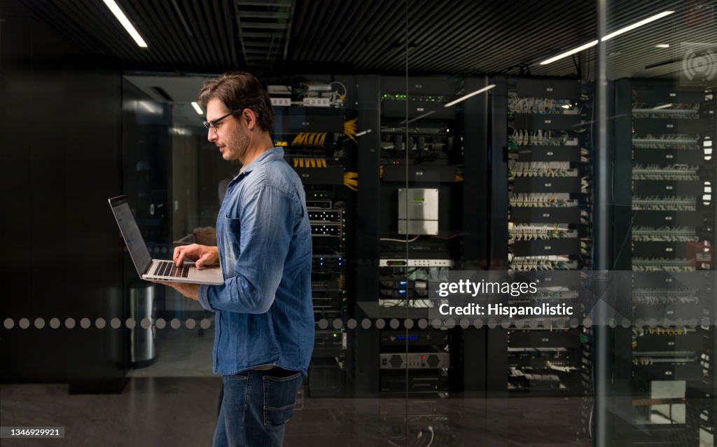 IT technician fixing an outage on a network server
