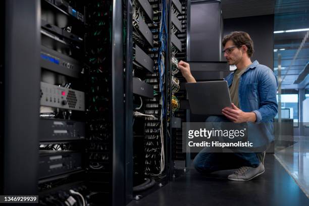 it support technician fixing a network server at an office - glitch technique stockfoto's en -beelden