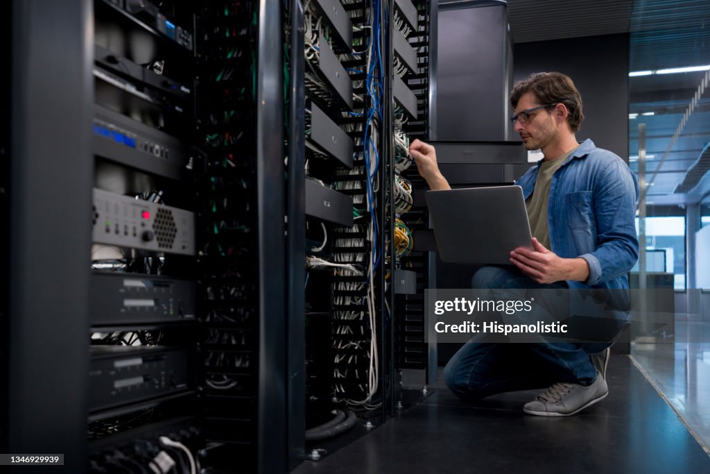 IT support technician fixing a network server at an office