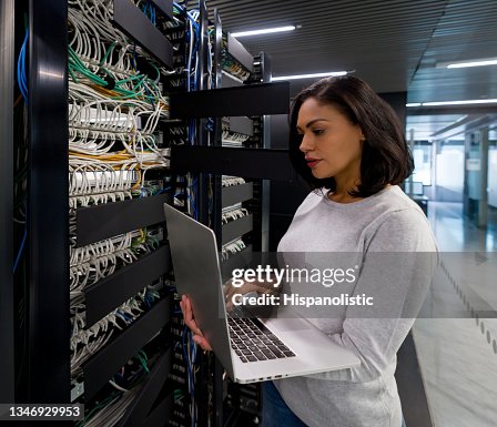 Computer engineer fixing a network server at an office Computer engineer fixing a network server at an office