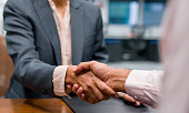 Close-up on business people closing a deal with a handshake