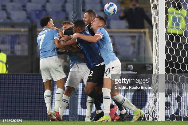 Felipe Anderson and Sergej Milinkovic-Savic of SS Lazio clash with Denzel Dumfries of FC Internazionale during the Serie A match between SS Lazio and...