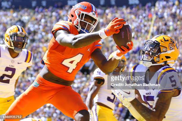 Justin Shorter of the Florida Gators catches the ball for a touchdown on a Hail Mary pass as Jay Ward of the LSU Tigers defends during the first half...