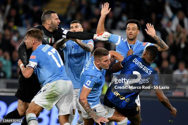 Felipe Anderson and Sergej Milinkovic Savic of SS Lazio clash with Denzel Dumfries of FC Internazionale during the Serie A match between SS Lazio and...
