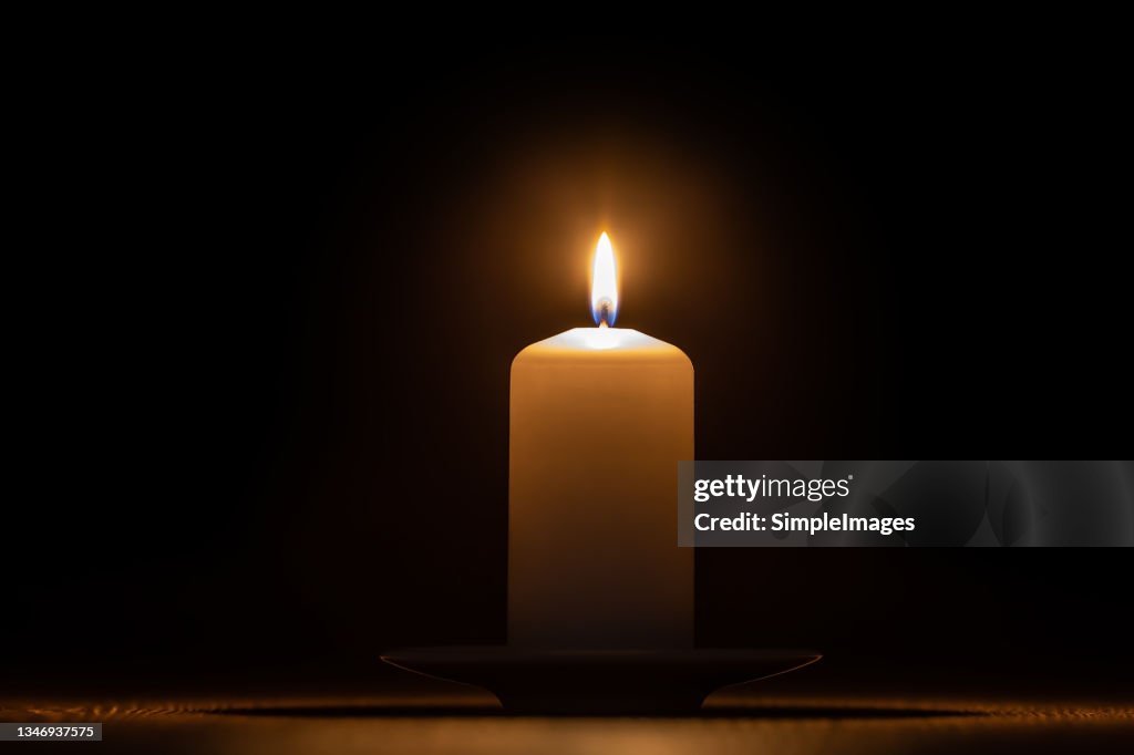 The wax candle glows in the dark.