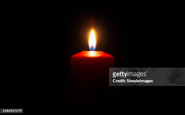 the wax candle glows in the dark. - candel stockfoto's en -beelden