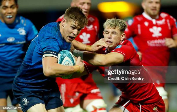 Garry Ringrose of Leinster is tackled by Tom Rogers of Scarlets during the United Rugby Championship match between Leinster and Scarlets at RDS Arena...