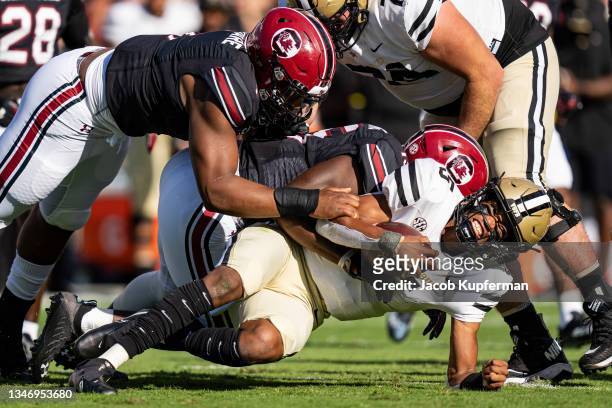 Quarterback Mike Wright of the Vanderbilt Commodores is sacked by defensive end Kingsley Enagbare of the South Carolina Gamecocks, left, and...