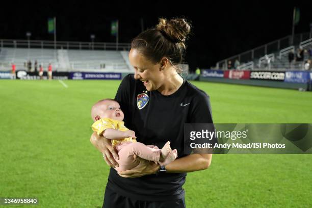 Equipment manager Vannessa Fulcher of the North Carolina Courage holds Roo Thackery, the infant daughter of the team"u2019s assistant coach Nathan...