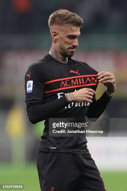 Samuel Castillejo of AC Milan looks for the club badge on his jersey as he celebrates after scoring to give the side a 3-2 lead during the Serie A...