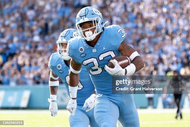 Cedric Gray of the North Carolina Tar Heels returns an interception against the Miami Hurricanes during the first half of their game at Kenan...