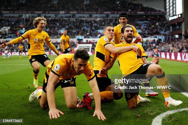 Ruben Neves of Wolverhampton Wanderers celebrates with teammates after scoring his team's third goal during the Premier League match between Aston...
