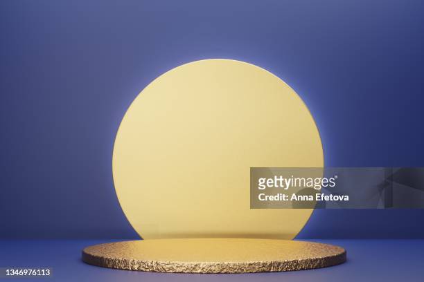 golden textured podium for product demonstration. three  dimensional stage on blue background. front view. creative trendy concept of the year. - beauty cosmetic luxury studio background stock-fotos und bilder