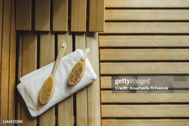 dry cactus brush  and white towel for anti-cellulite dry body massage to prevent cellulite and body problem. - natural organic thermo cosmetics stock pictures, royalty-free photos & images