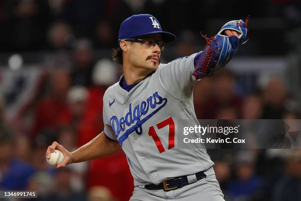 Joe Kelly of the Los Angeles Dodgers delivers a pitch against the Atlanta Braves during the seventh inning of Game One of the National League...