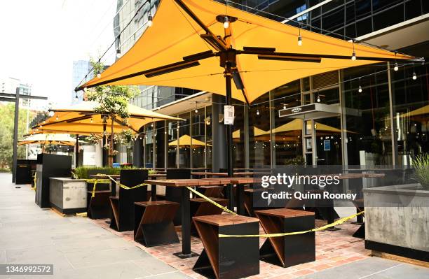 Empty outside dining tables in Southbank are seen on October 17, 2021 in Melbourne, Australia. Premier Andrews announced that Victoria's Lockdown...