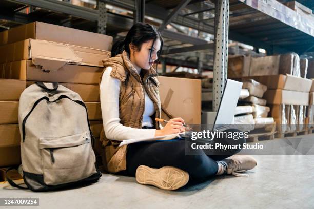 student taking study break at work - avondschool stockfoto's en -beelden