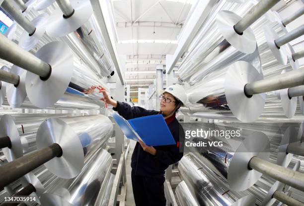 An employee works on the production line of aluminum foil at a factory on October 17, 2021 in Huaibei, Anhui Province of China.