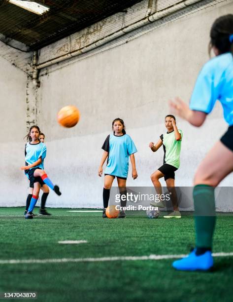 girls practicing soccer at indoor field - indoor football pitch stock pictures, royalty-free photos & images