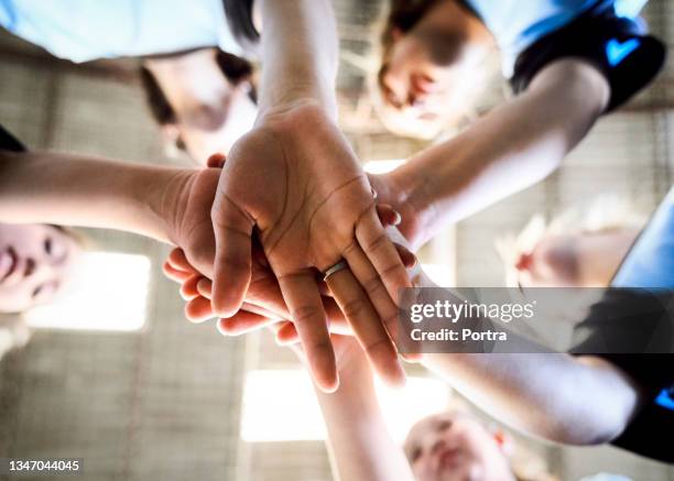 girls soccer team with their hands stacked - women power stock pictures, royalty-free photos & images