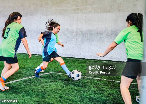 girls soccer match on sports court - indoor soccer stock pictures, royalty-free photos & images