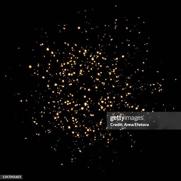 splash of glittering golden confetti on black isolated background. christmas and new year concept in trendy festive golden color. - confetti gold ストックフォトと画像