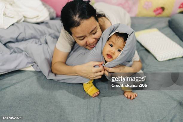 funny moment mother  positive emotion playing seek and hide with daughter at  the cozy bedroom domestic life - pregnant muslim stock pictures, royalty-free photos & images