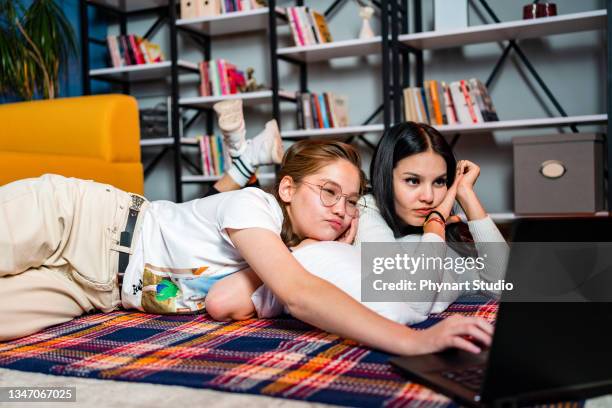 two young women friends sharing happy time together - lying on front stock pictures, royalty-free photos & images