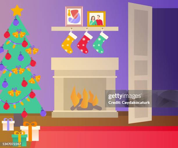 living room interior with christmas tree, gift boxes, burning fireplace and picture frames. - cozy winter stock illustrations