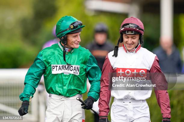 Daryl Jacob chats with Adam Wedge at Kempton Park Racecourse on October 17, 2021 in Sunbury, England.