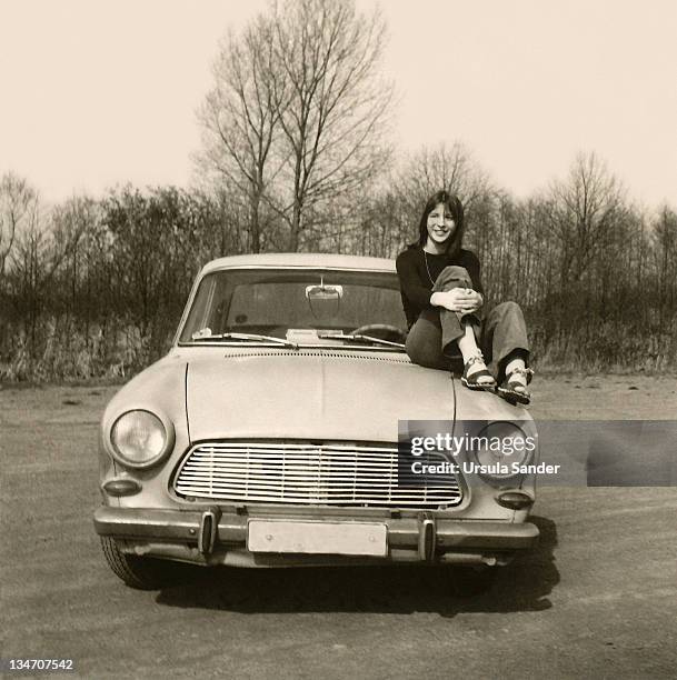 young woman sitting on car - vintage car bildbanksfoton och bilder