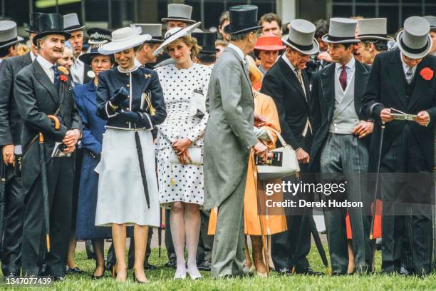 View of Anne, Princess Royal , in a blue blazer and white skirt, and Diana, Princess of Wales , in a black and white, polka-dot dress and a matching,...