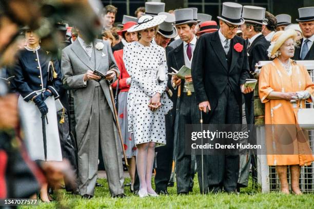 View of married couple Diana, Princess of Wales , in a black and white, polka-dot dress and a matching, wide-brimmed hat, and Charles, Prince of...