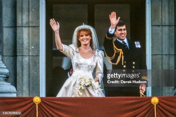 View of just-married couple Sarah, Duchess of York, and Prince Andrew, Duke of York, as they wave from the balcony of Buckingham Palace, London,...