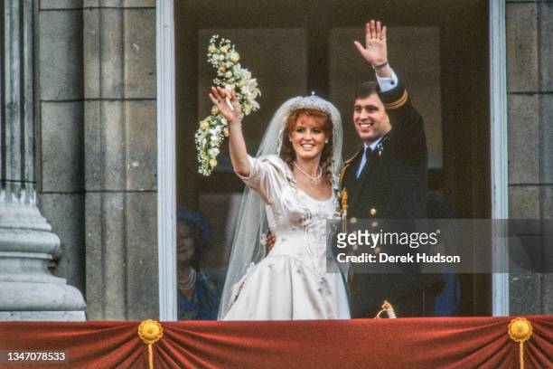 View of just-married couple Sarah, Duchess of York, and Prince Andrew, Duke of York, as they wave from the balcony of Buckingham Palace, London,...