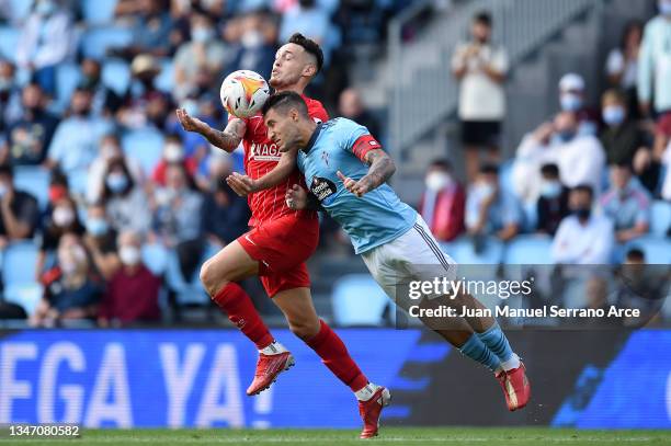 Hugo Mallo of Celta Vigo jumps for the ball with Lucas Ocampos of Sevilla during the LaLiga Santander match between RC Celta de Vigo and Sevilla FC...