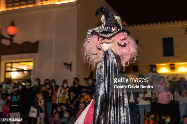 An actress disguised as a witch performs in the Halloween parade at Warner Bros Park Madrid on October 16, 2021 in Madrid, Spain.
