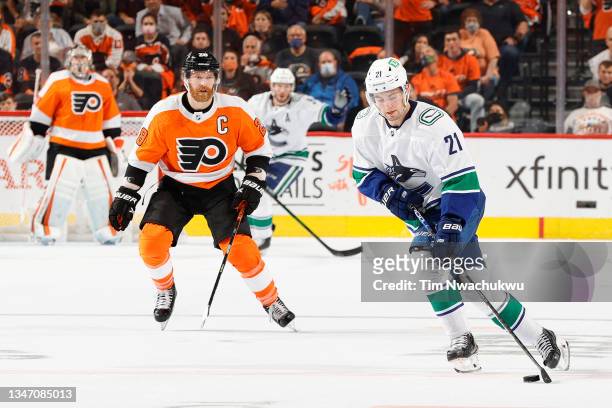 Nils Hoglander of the Vancouver Canucks controls the puck against the Philadelphia Flyers at Wells Fargo Center on October 15, 2021 in Philadelphia,...