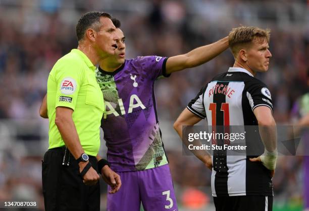 Match Referee, Andre Marriner looks on as Sergio Reguilon of Tottenham Hotspur points out a potential issue in the stand during the Premier League...