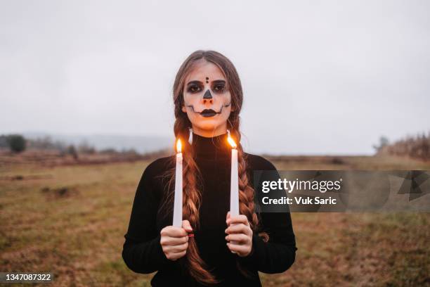 disguised woman holding candles - in flames i the mask stock pictures, royalty-free photos & images